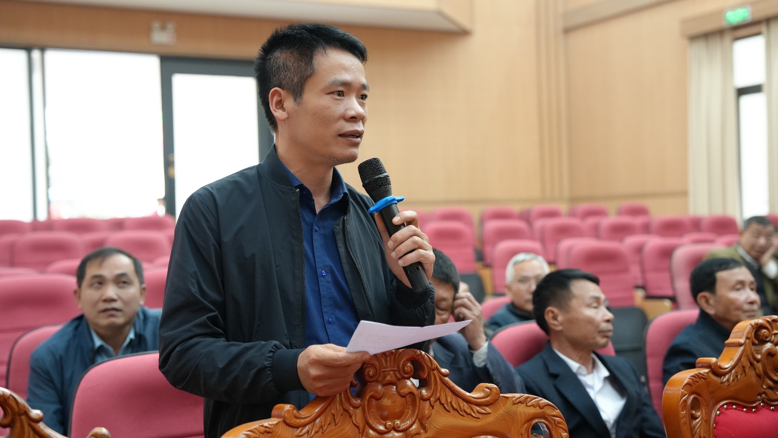 A person holding a microphone  AI-generated content may be incorrect.