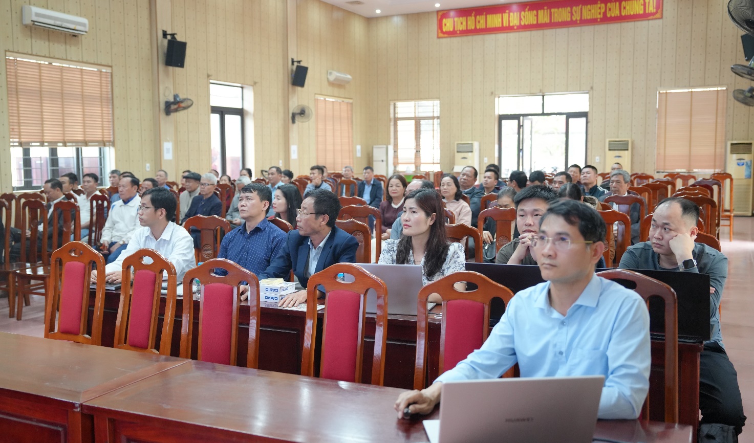 A group of people in a conference room  AI-generated content may be incorrect.