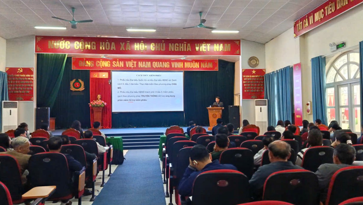 A person standing at a podium in front of a stage  AI-generated content may be incorrect.