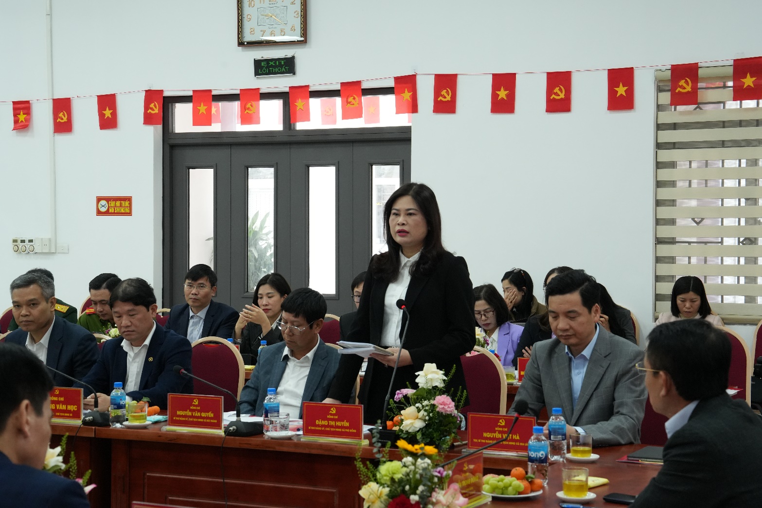 A person standing in front of a group of people  AI-generated content may be incorrect.