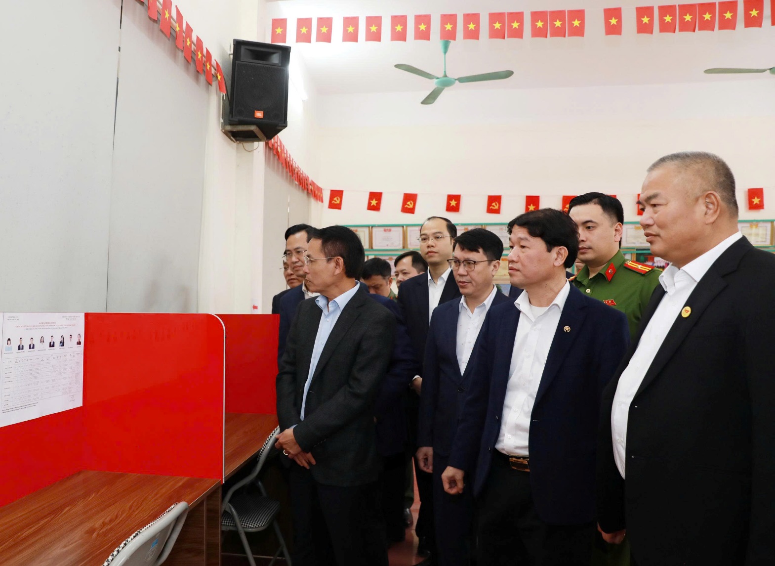 A group of men standing in a room  AI-generated content may be incorrect.