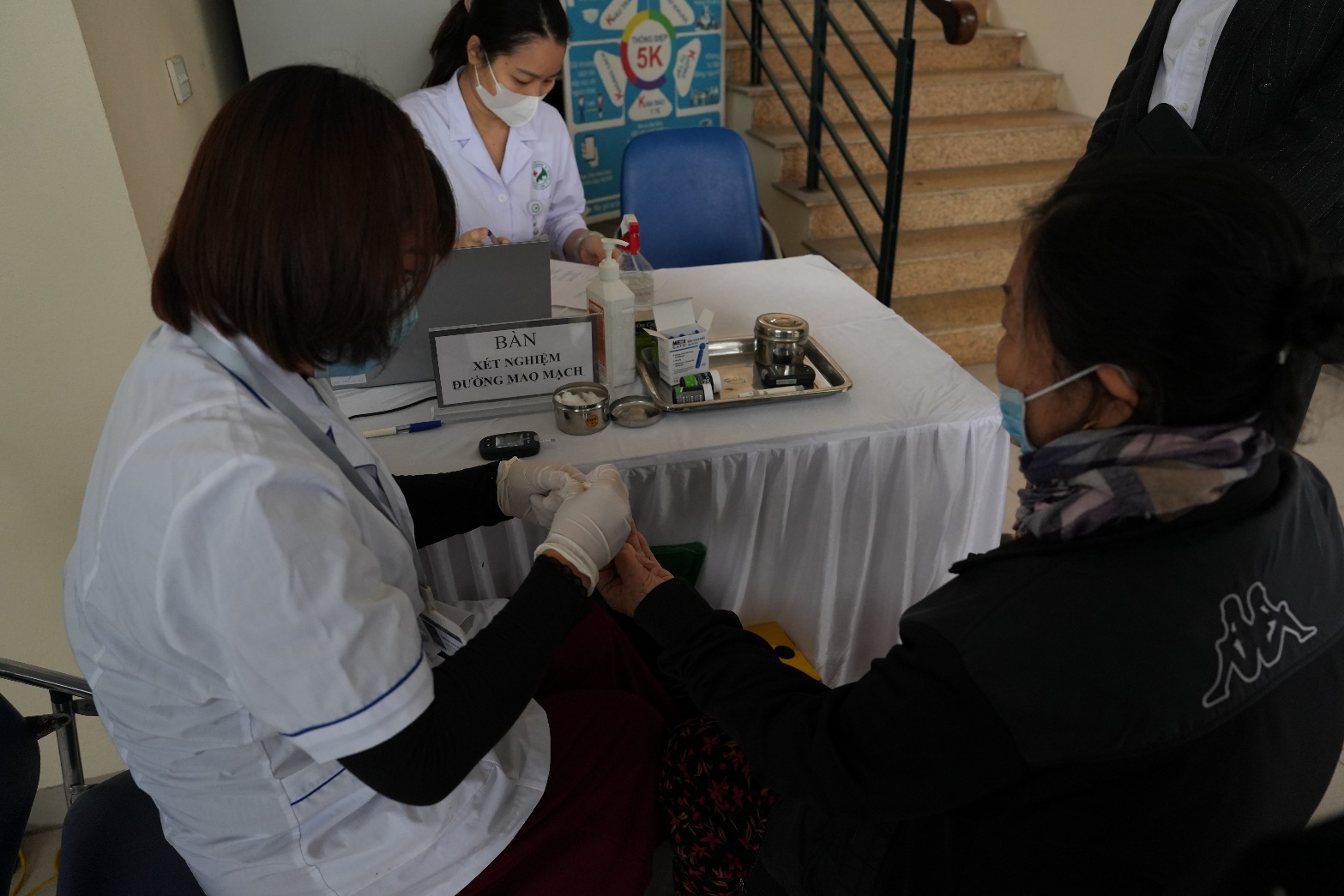 A doctor giving a blood test to a patient  AI-generated content may be incorrect.