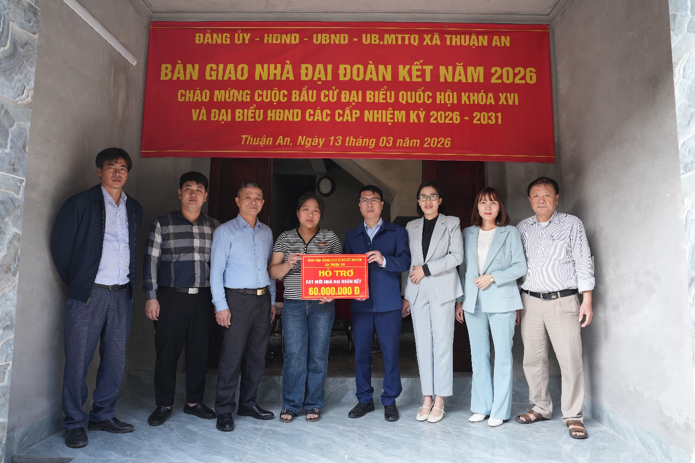 A group of people standing in front of a banner  AI-generated content may be incorrect.