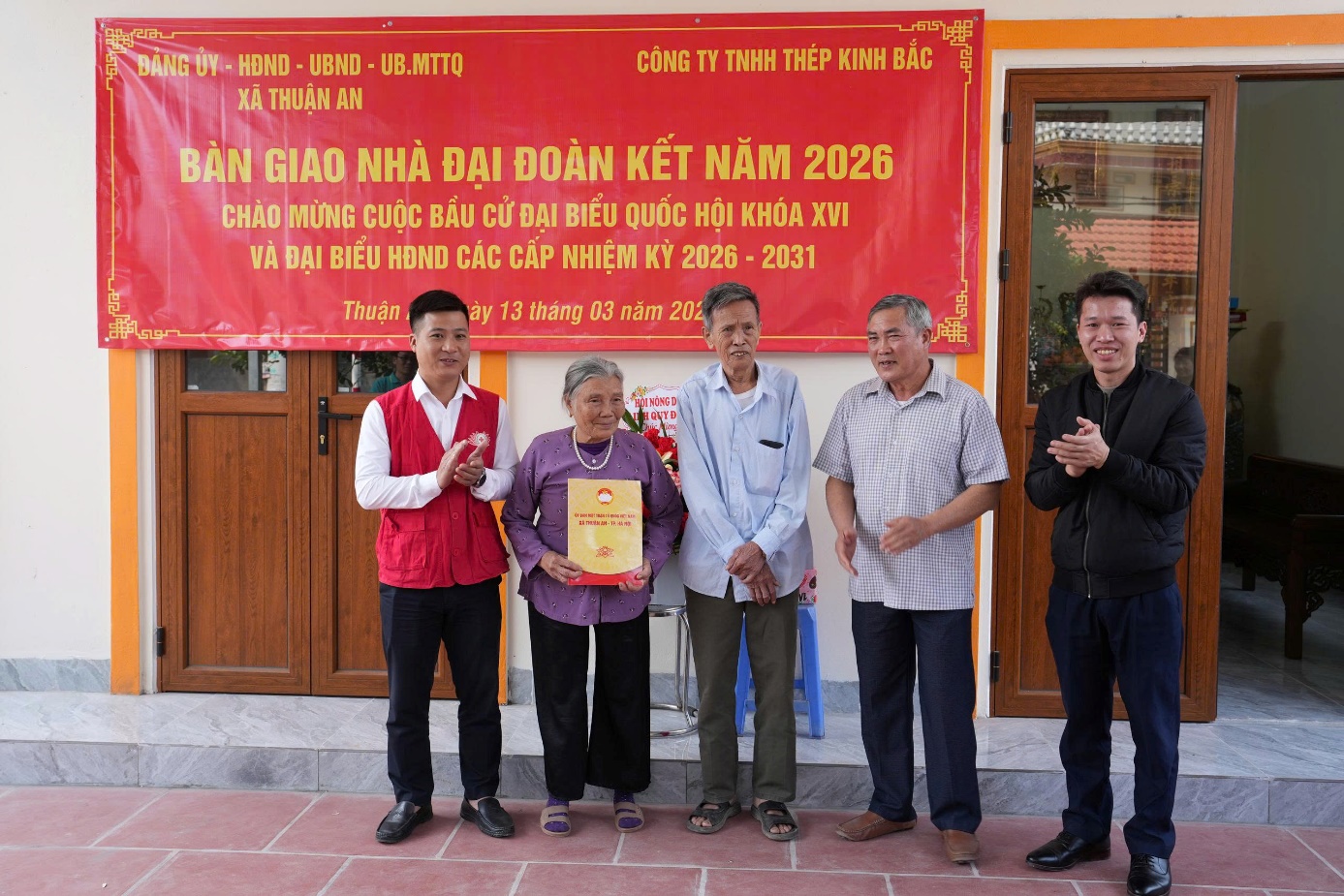 A group of people standing in front of a banner  AI-generated content may be incorrect.