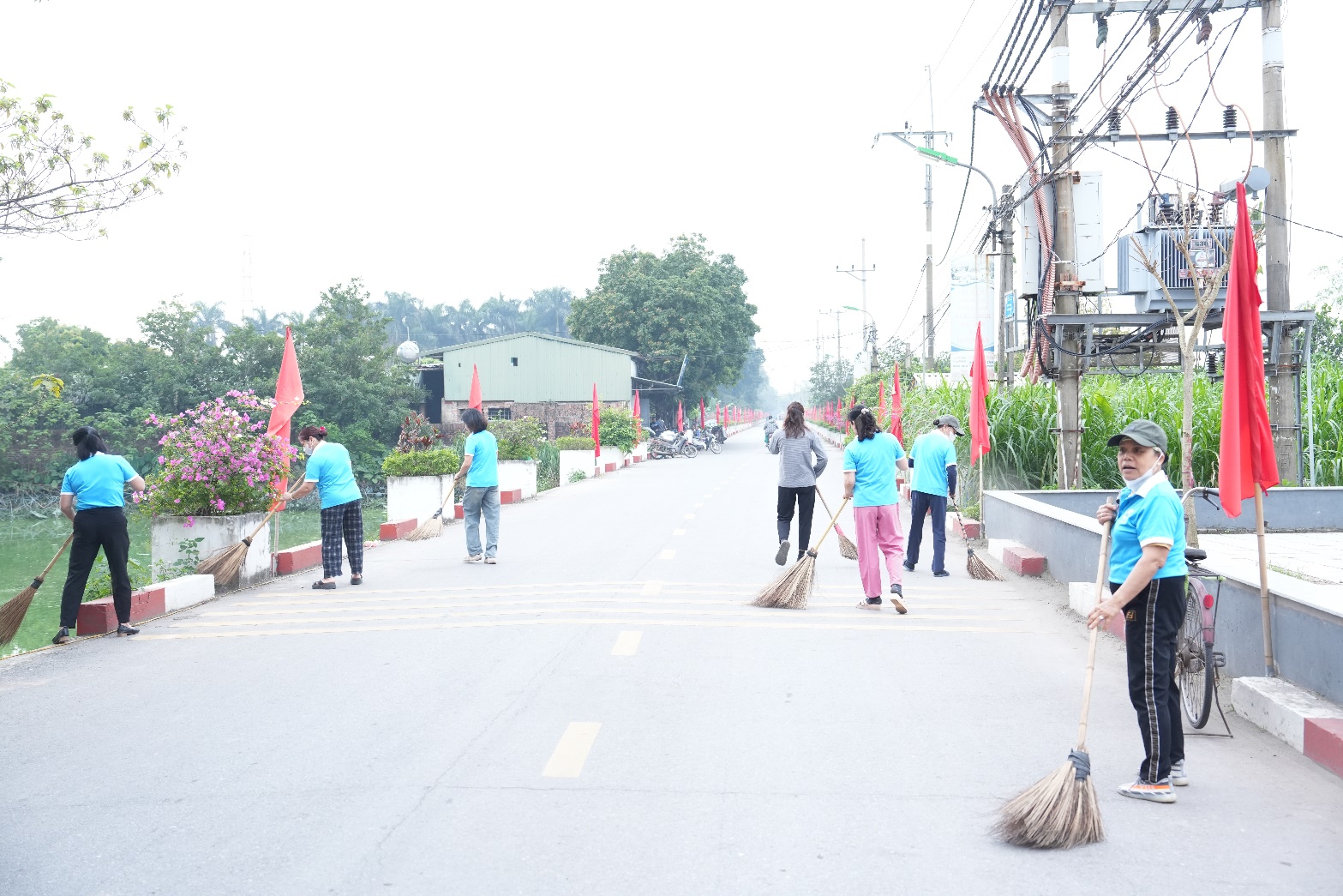 A group of people sweeping the street  AI-generated content may be incorrect.