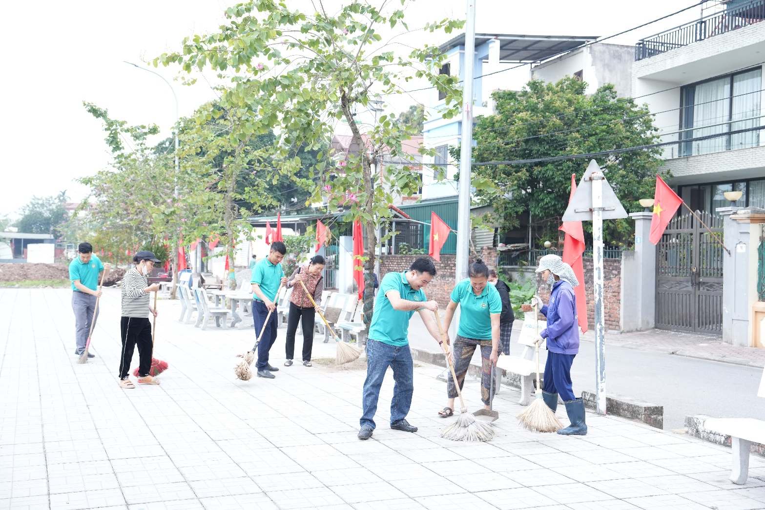 A group of people cleaning the sidewalk  AI-generated content may be incorrect.