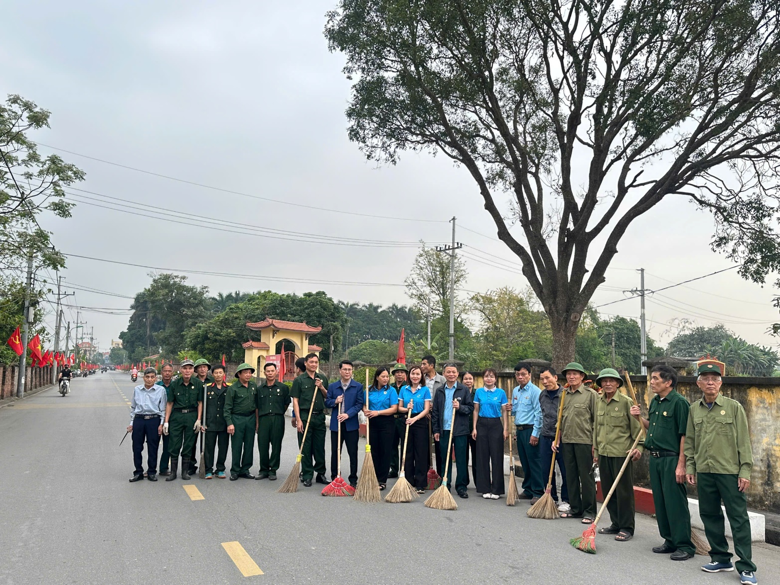 A group of people holding brooms  AI-generated content may be incorrect.