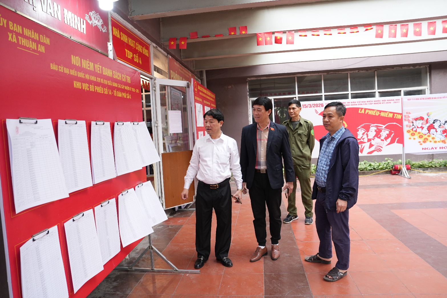 A group of men standing in front of a display of papers  AI-generated content may be incorrect.