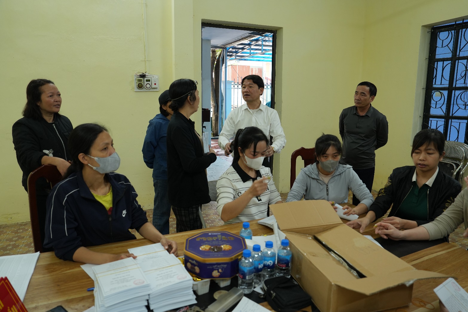 A group of people sitting around a table  AI-generated content may be incorrect.