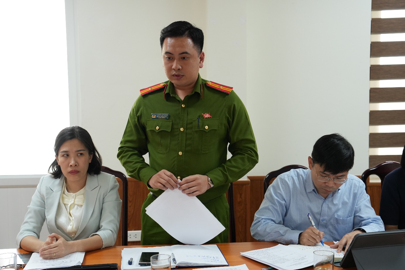 A person in a green uniform holding a piece of paper  AI-generated content may be incorrect.