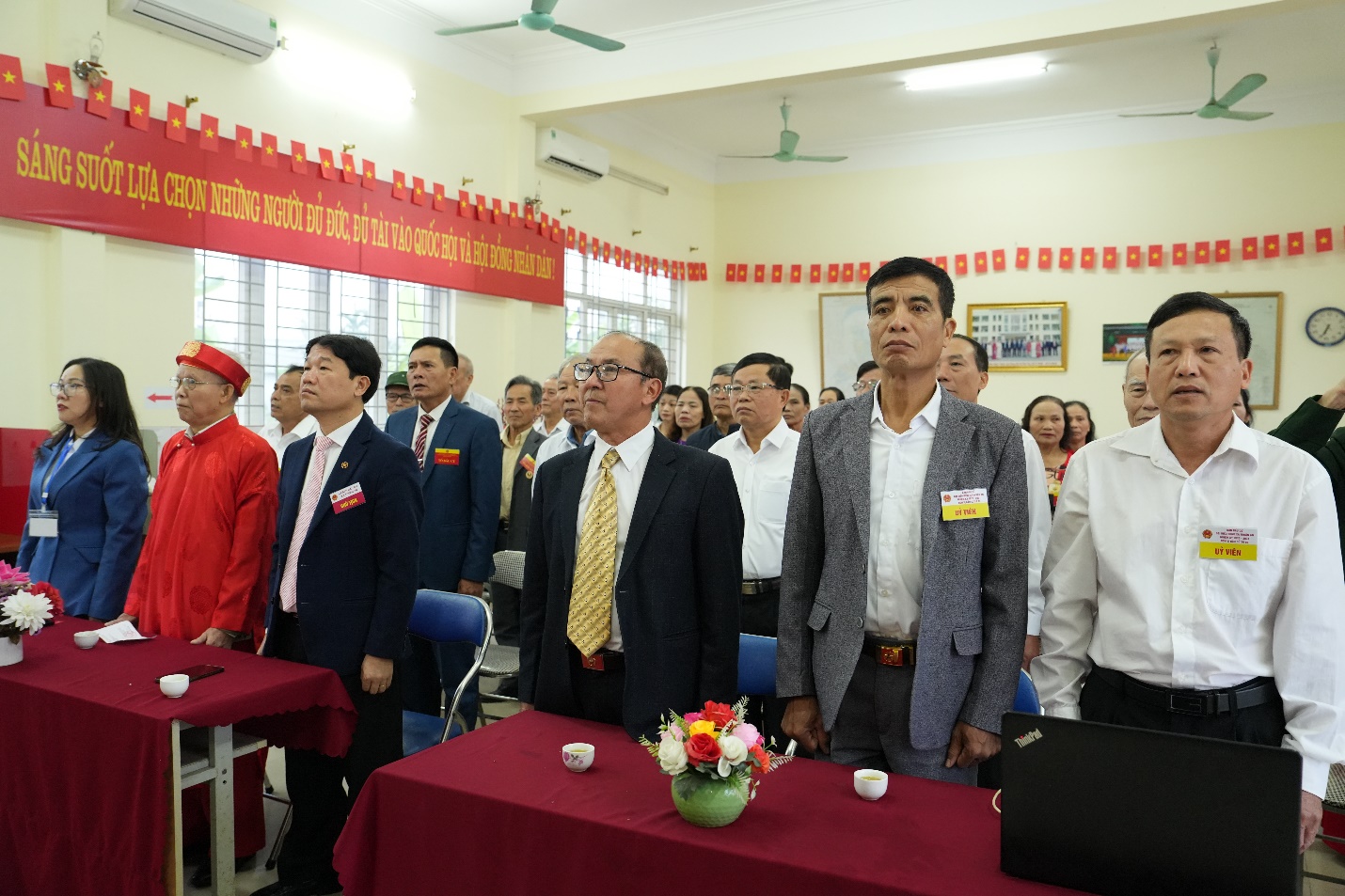 A group of people standing in a room  AI-generated content may be incorrect.