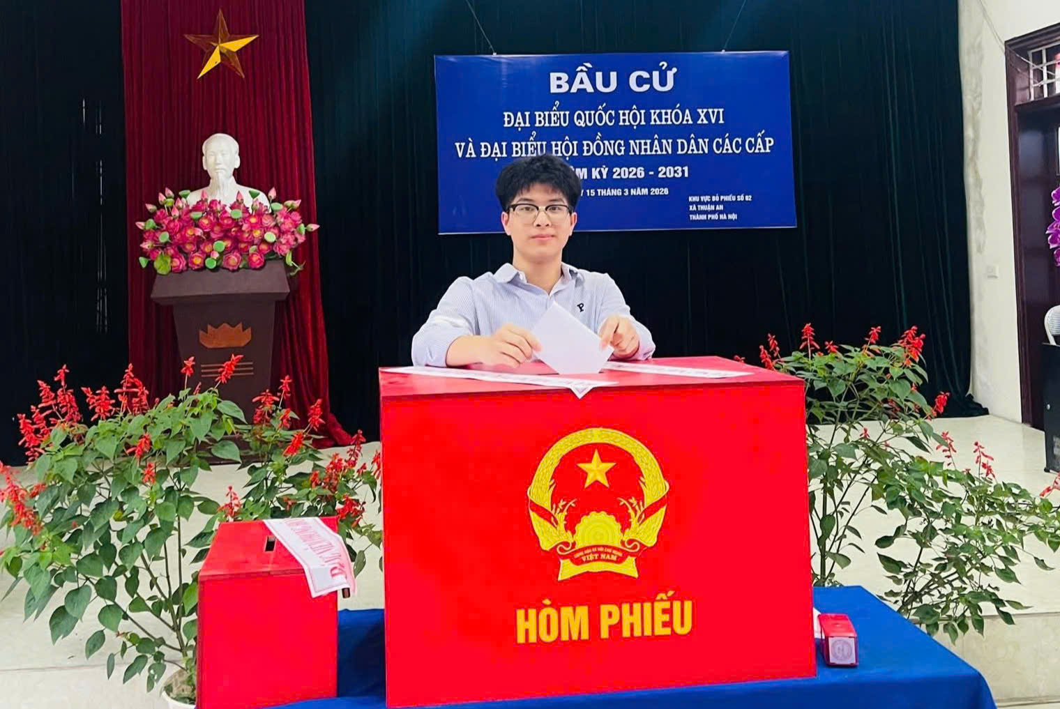 A person standing behind a red box  AI-generated content may be incorrect.