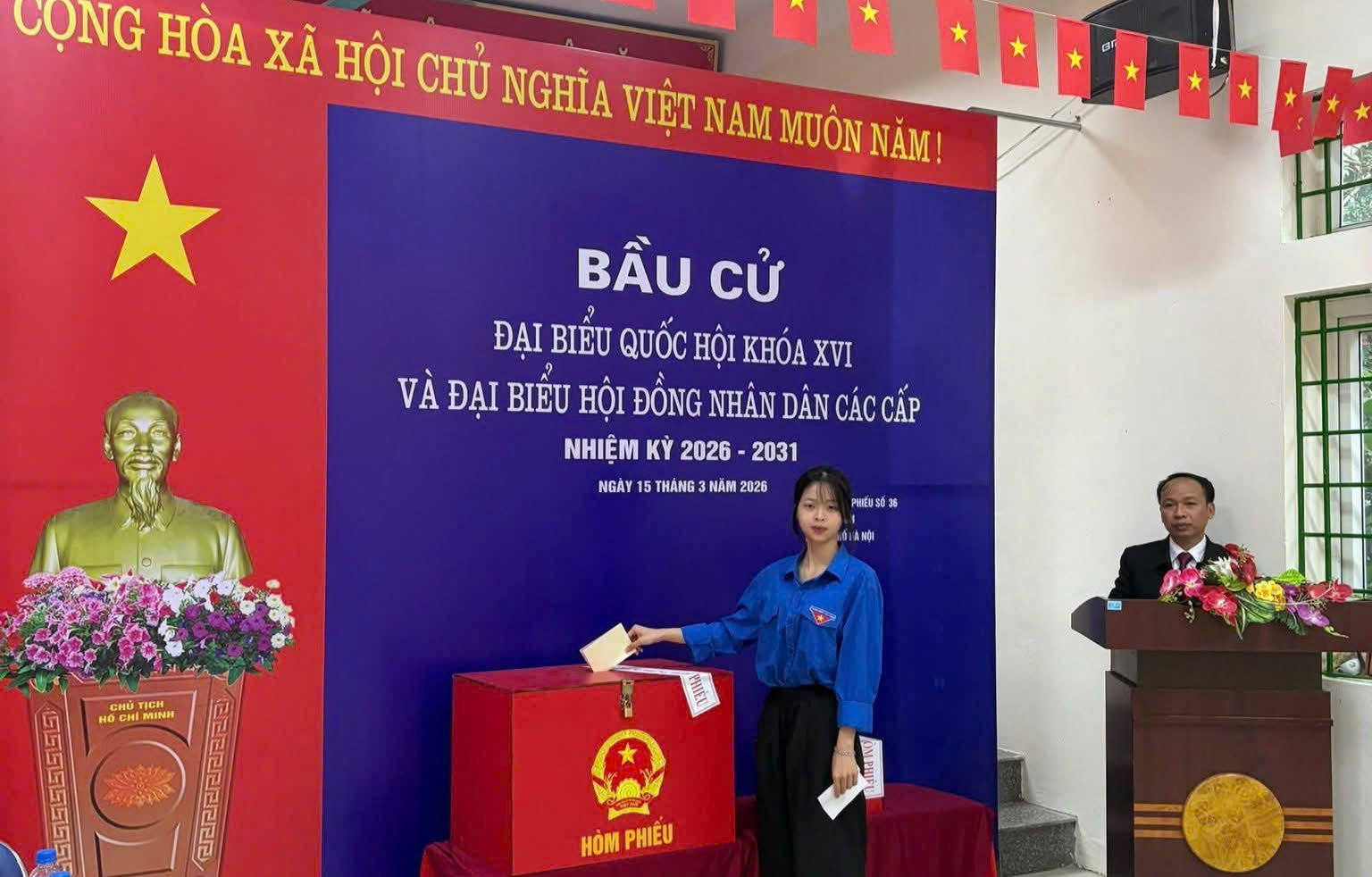 A person standing next to a red box  AI-generated content may be incorrect.