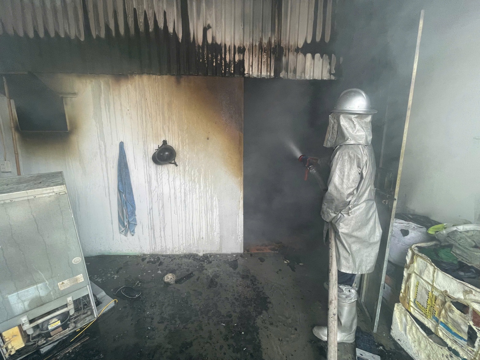 A firefighter spraying a fire  AI-generated content may be incorrect.