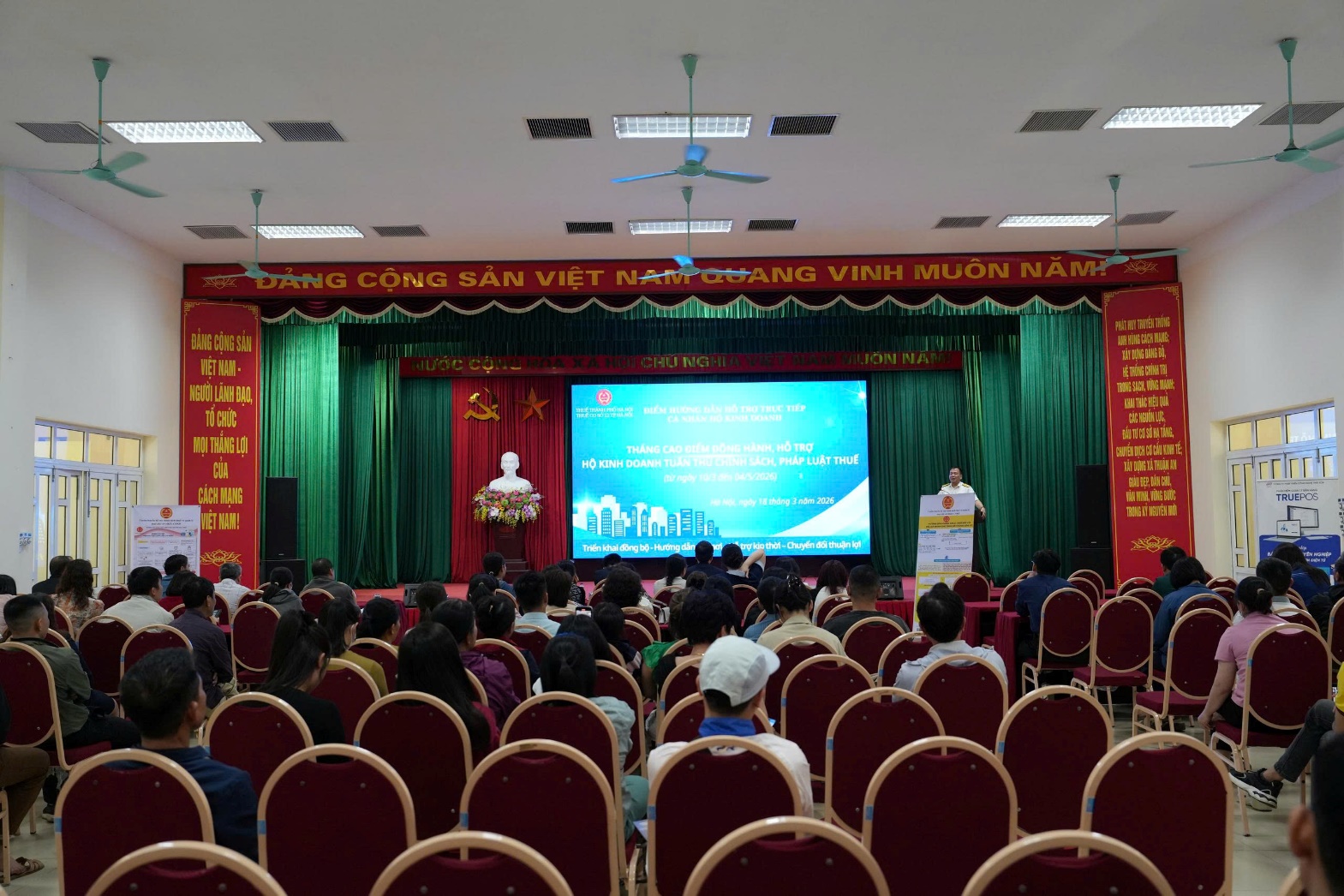 A group of people sitting in chairs in front of a stage  AI-generated content may be incorrect.