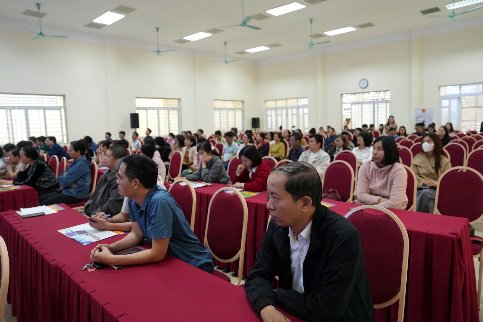 A group of people sitting in a room  AI-generated content may be incorrect.