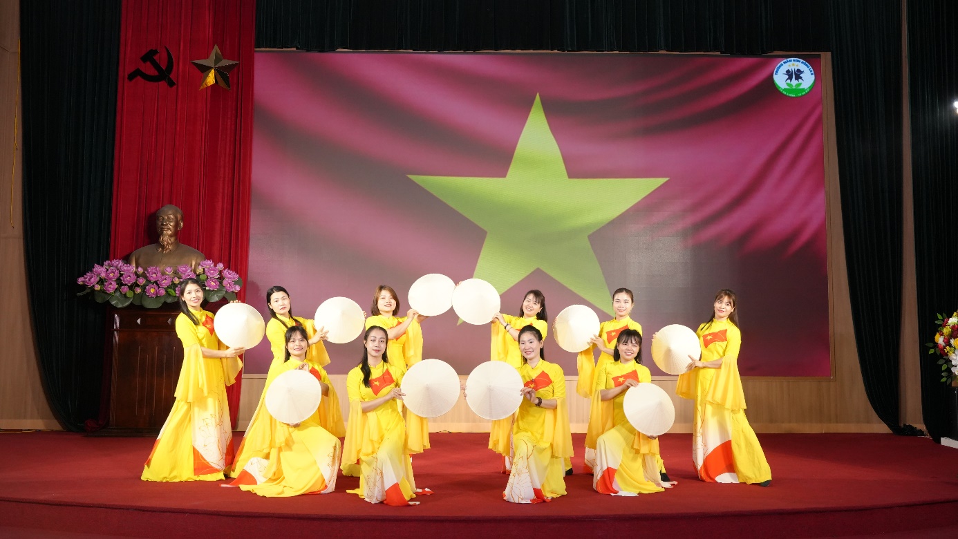 A group of women in yellow dresses on a stage  AI-generated content may be incorrect.