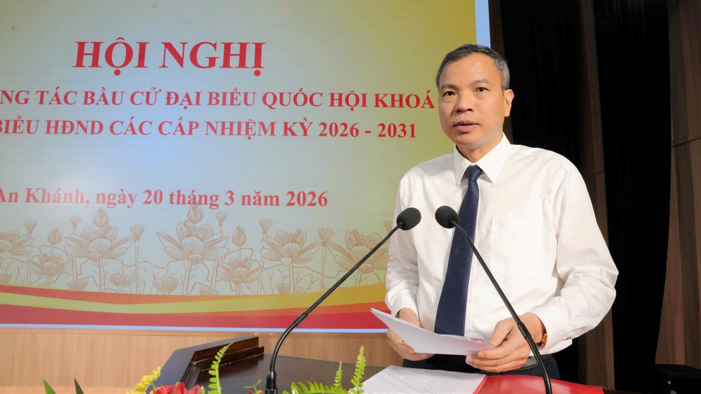 A person standing at a podium with microphones  AI-generated content may be incorrect.