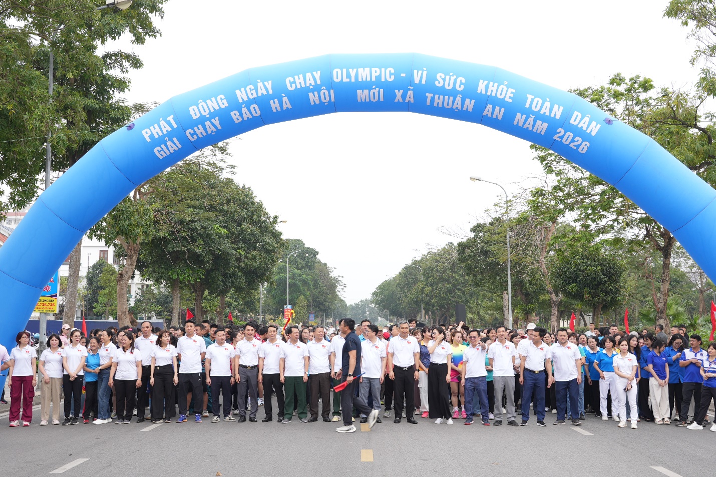 A group of people standing under a blue arch  AI-generated content may be incorrect.