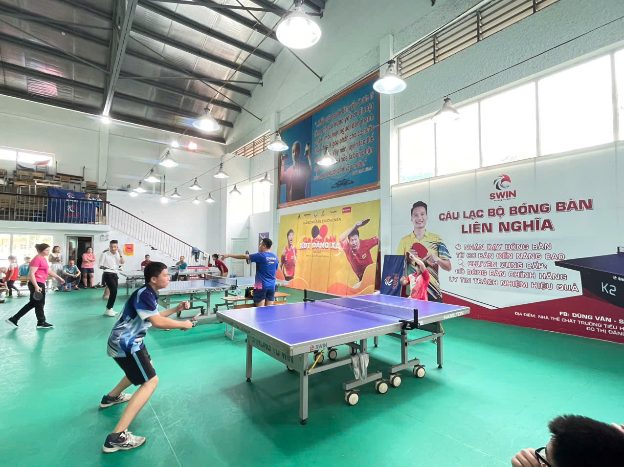 A group of people playing ping pong  AI-generated content may be incorrect.