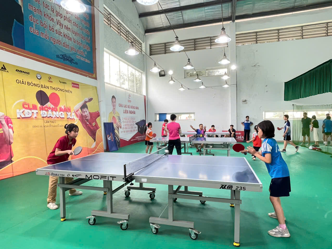 A group of people playing ping pong  AI-generated content may be incorrect.