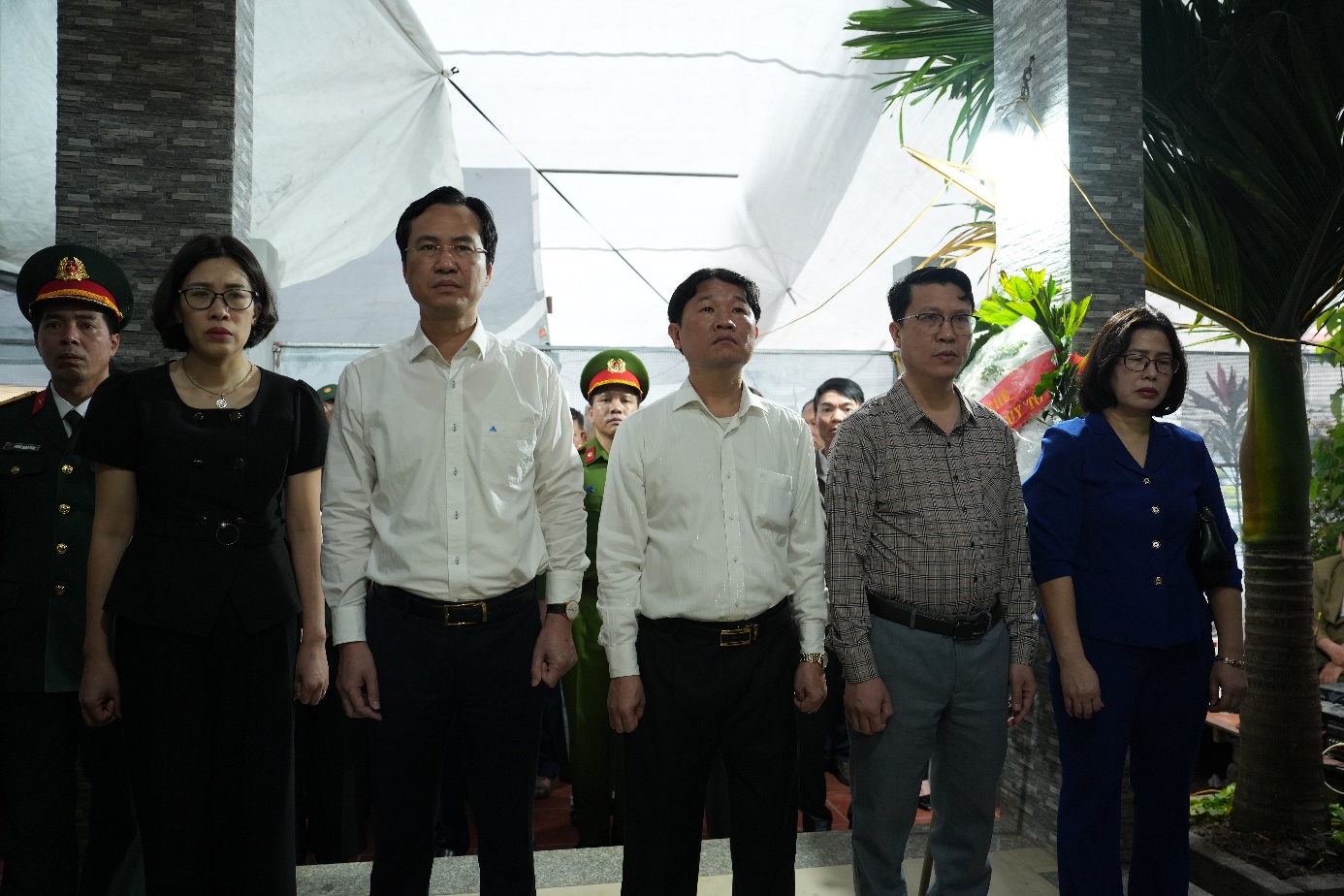 A group of people standing under a tent  AI-generated content may be incorrect.