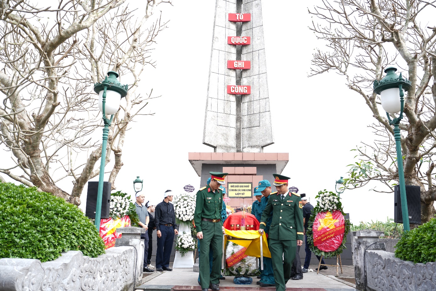 A group of people in uniform standing in front of a monument  AI-generated content may be incorrect.
