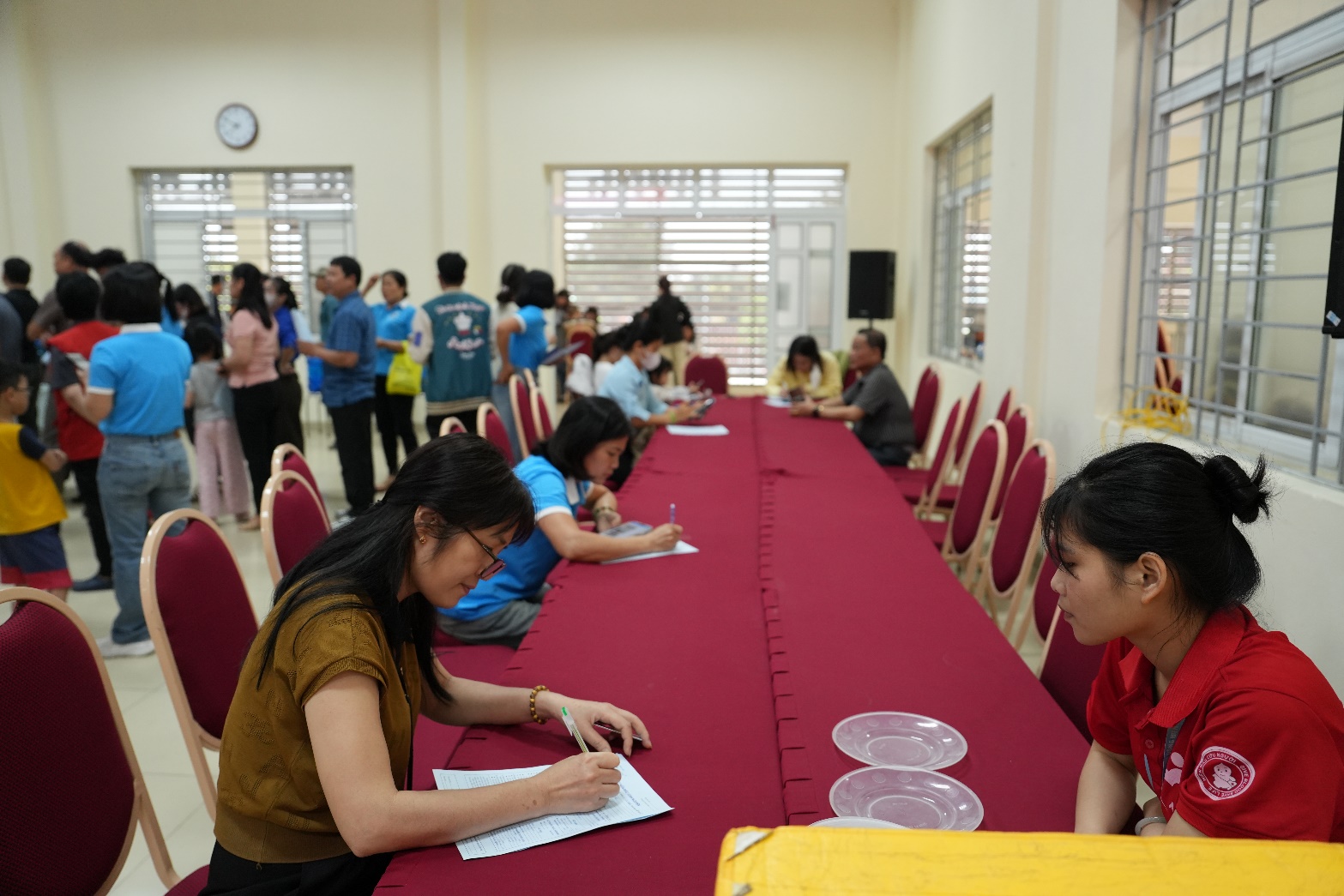 A group of people sitting at a long table  AI-generated content may be incorrect.