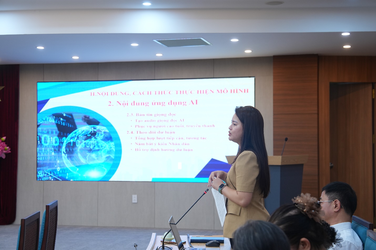 A person standing in front of a large screen