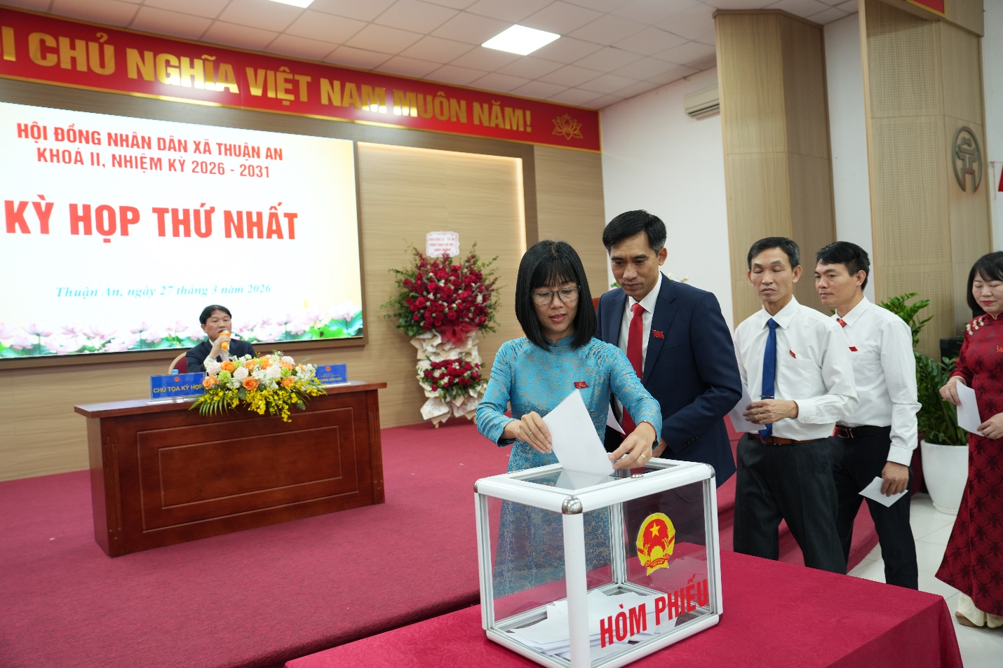 A person putting a ballot in a box  AI-generated content may be incorrect.