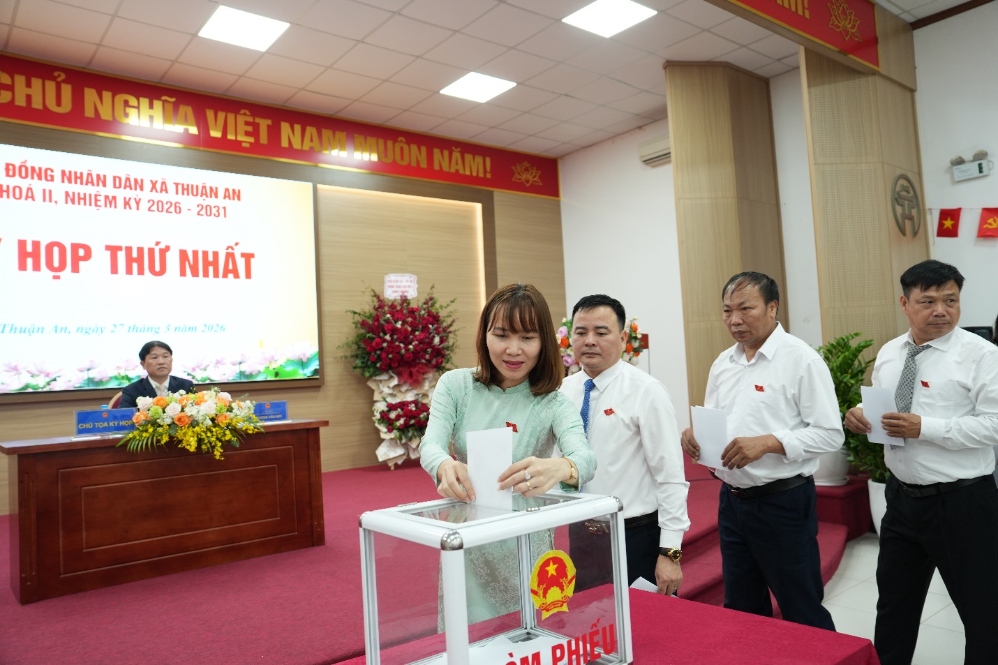 A person voting in a ballot box  AI-generated content may be incorrect.