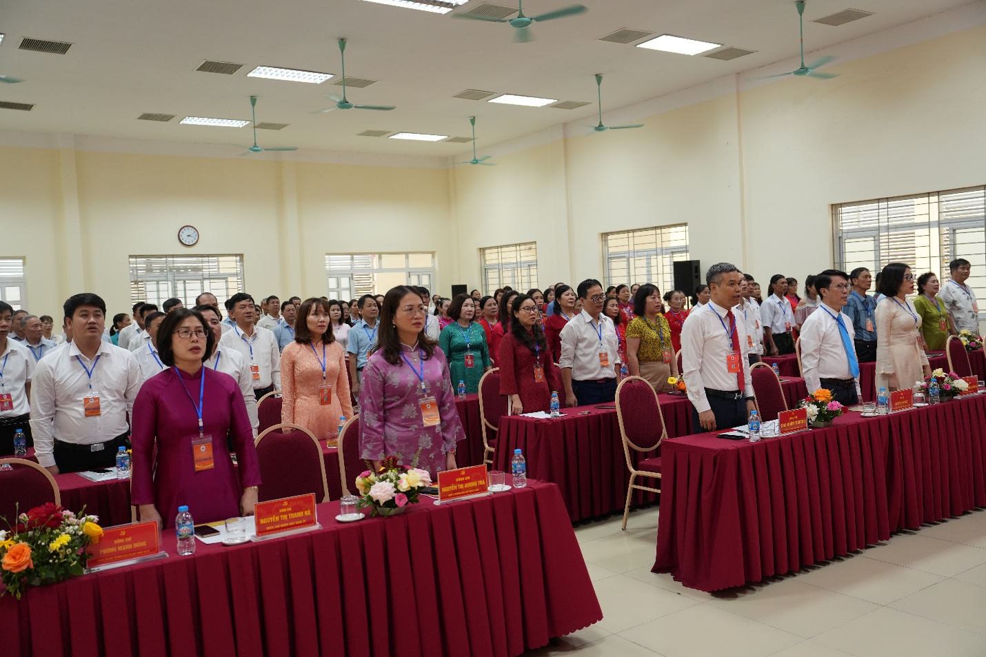 A group of people standing in a room  AI-generated content may be incorrect.