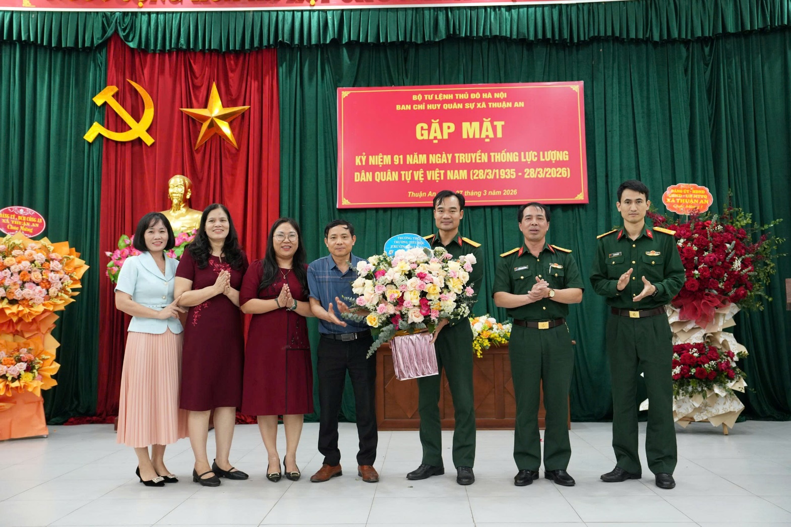 A group of people standing in front of a banner  AI-generated content may be incorrect.