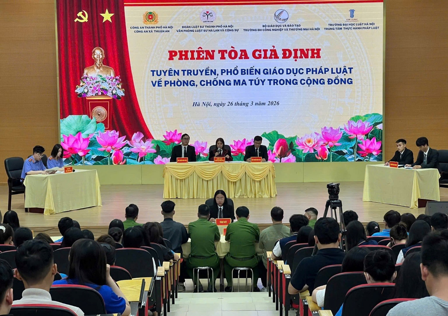 A group of people sitting in chairs in front of a stage  AI-generated content may be incorrect.