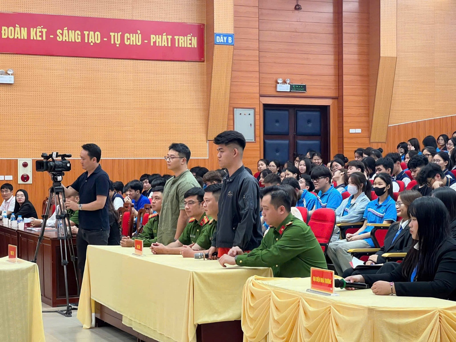 A person standing in front of a group of people  AI-generated content may be incorrect.