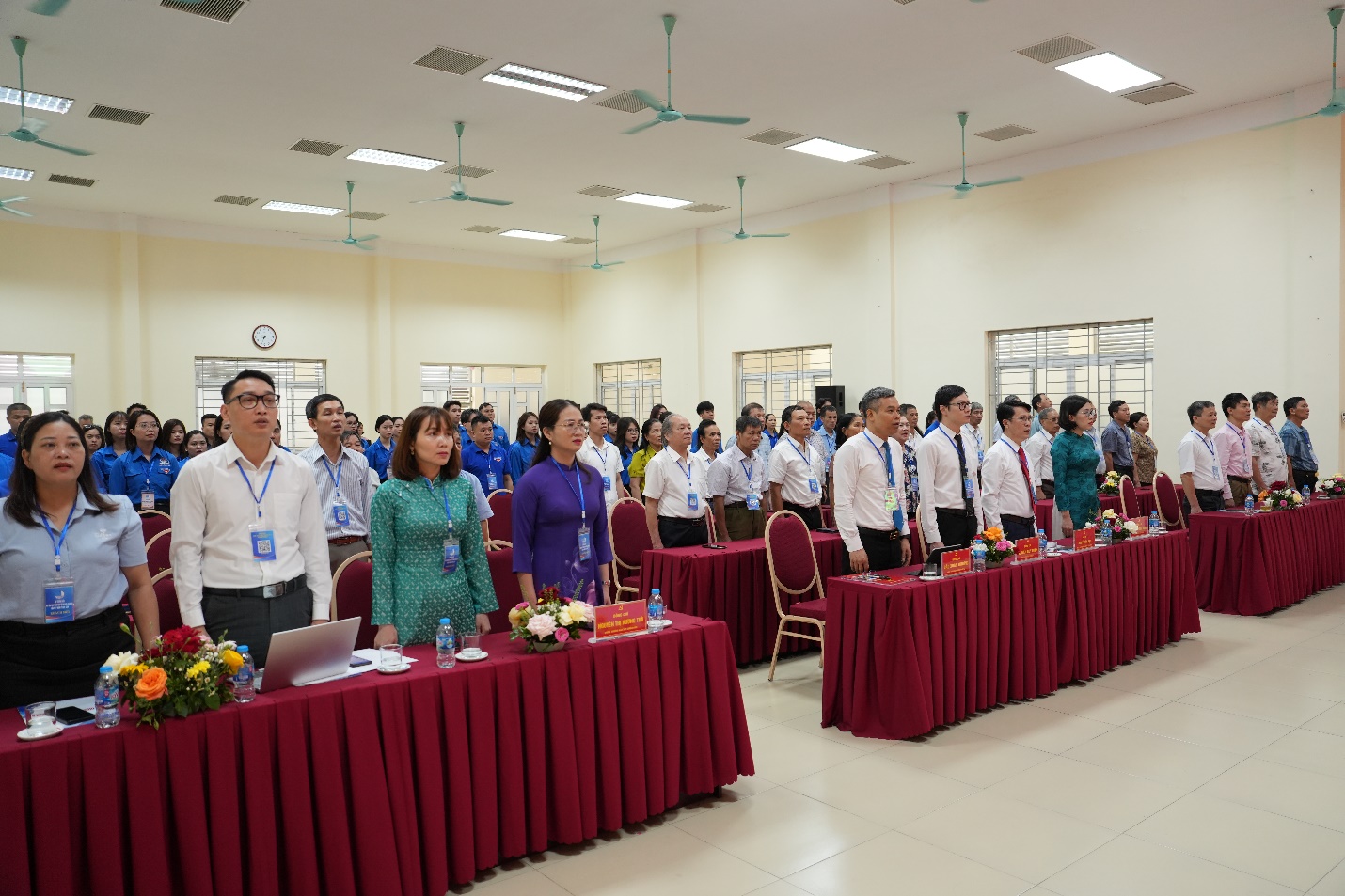 A group of people standing in a room  AI-generated content may be incorrect.