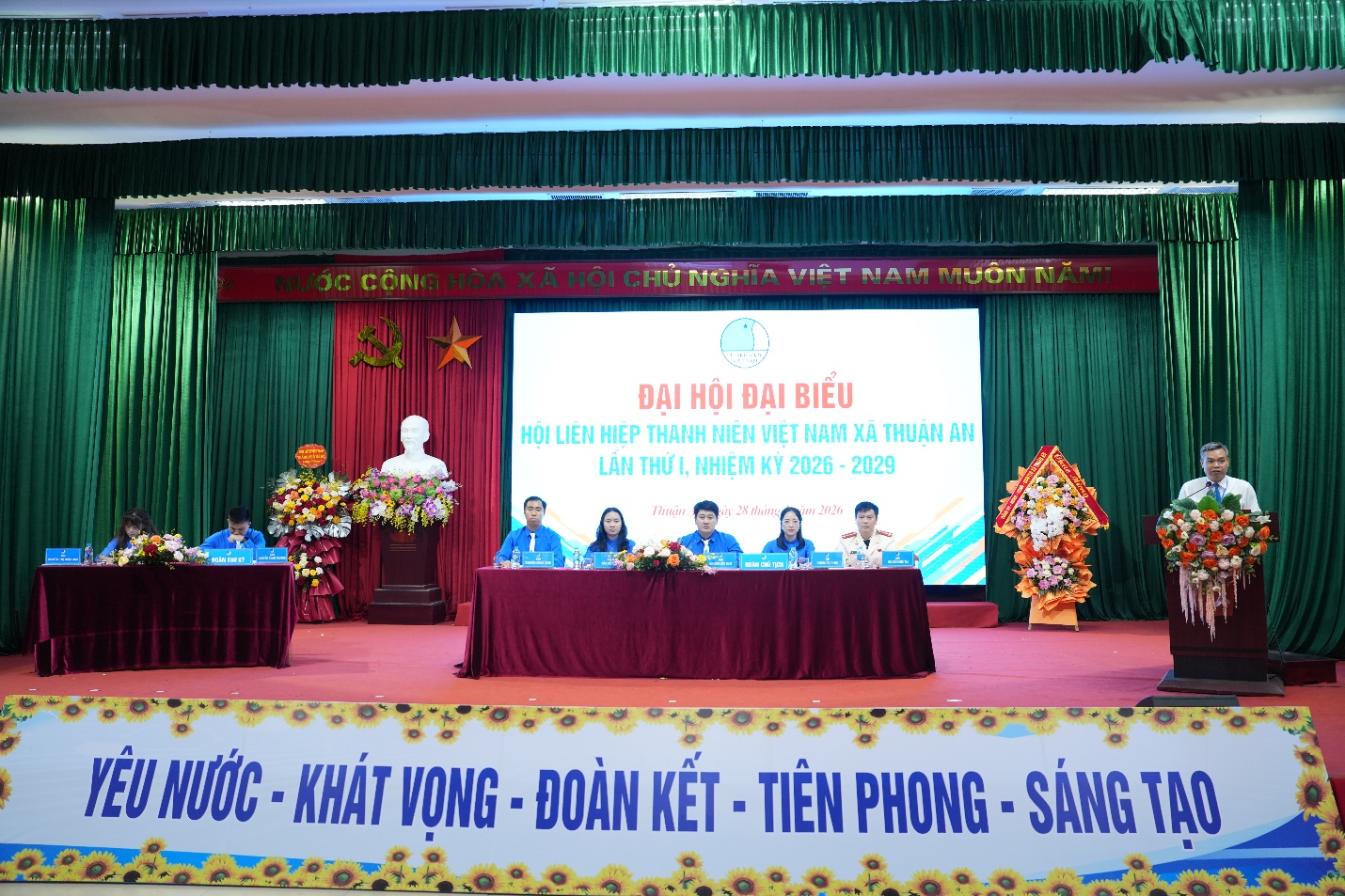 A group of people sitting on a stage  AI-generated content may be incorrect.