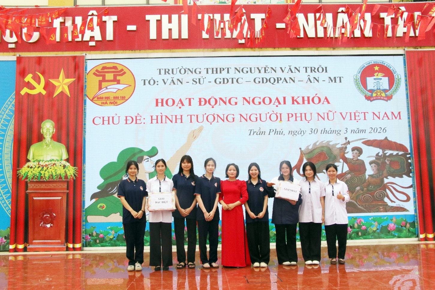 A group of people standing in front of a banner  AI-generated content may be incorrect.