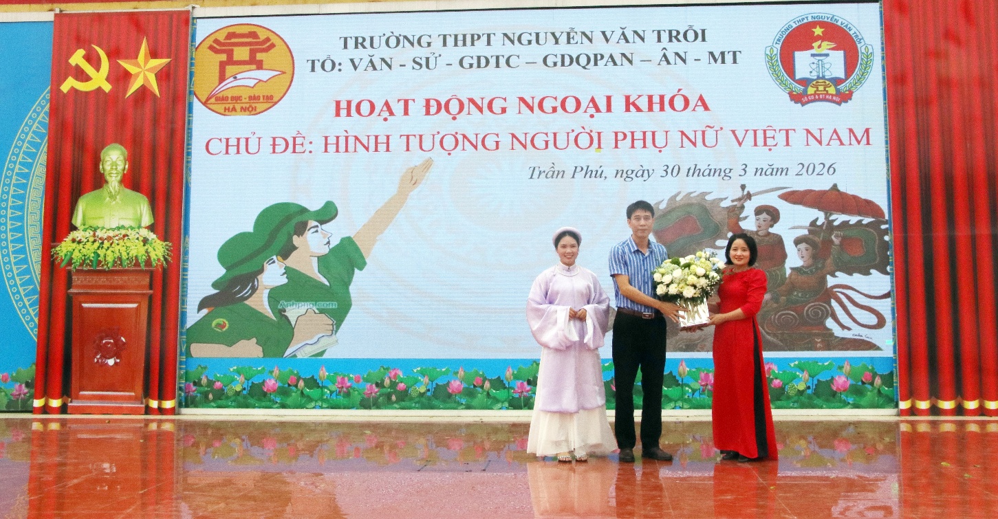 A group of people standing in front of a large banner  AI-generated content may be incorrect.