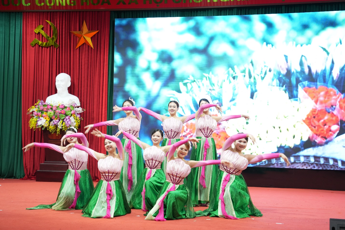 A group of women in green dresses on a stage  AI-generated content may be incorrect.