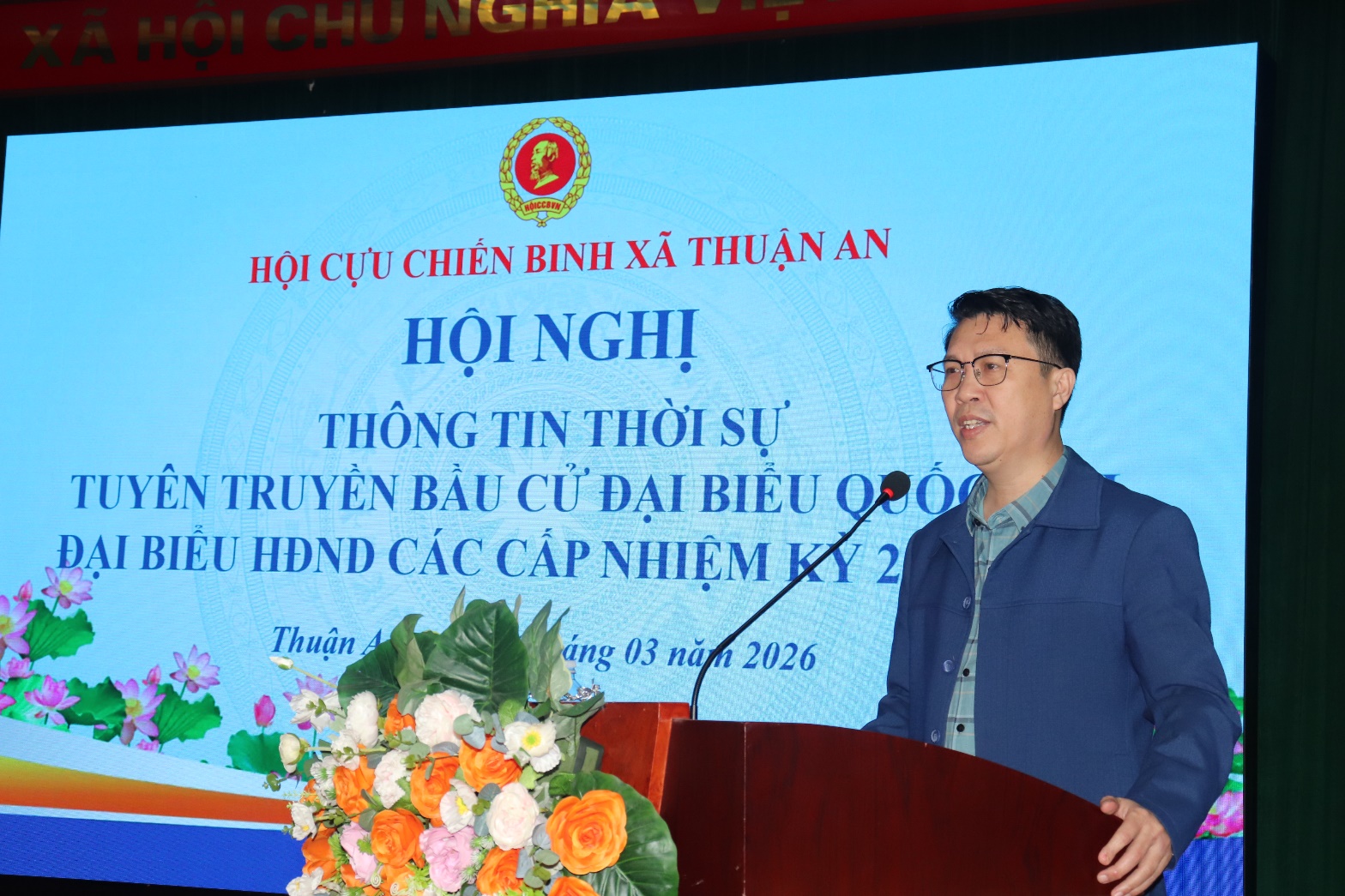 A person standing at a podium with a microphone  AI-generated content may be incorrect.