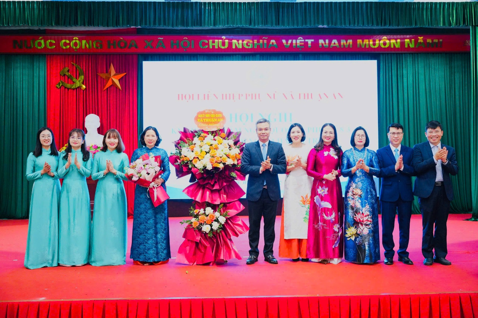 A group of people standing on a stage  AI-generated content may be incorrect.