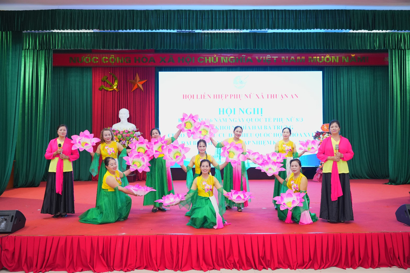 A group of women performing on a stage  AI-generated content may be incorrect.