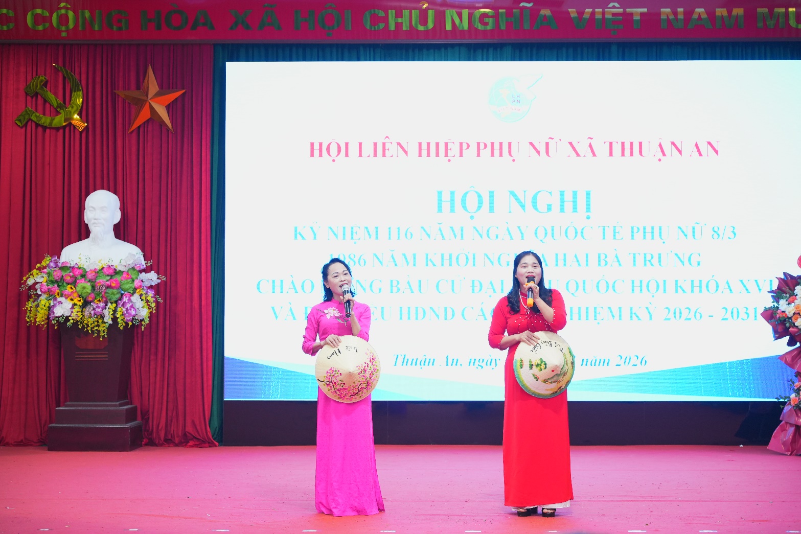 A group of women singing on a stage  AI-generated content may be incorrect.