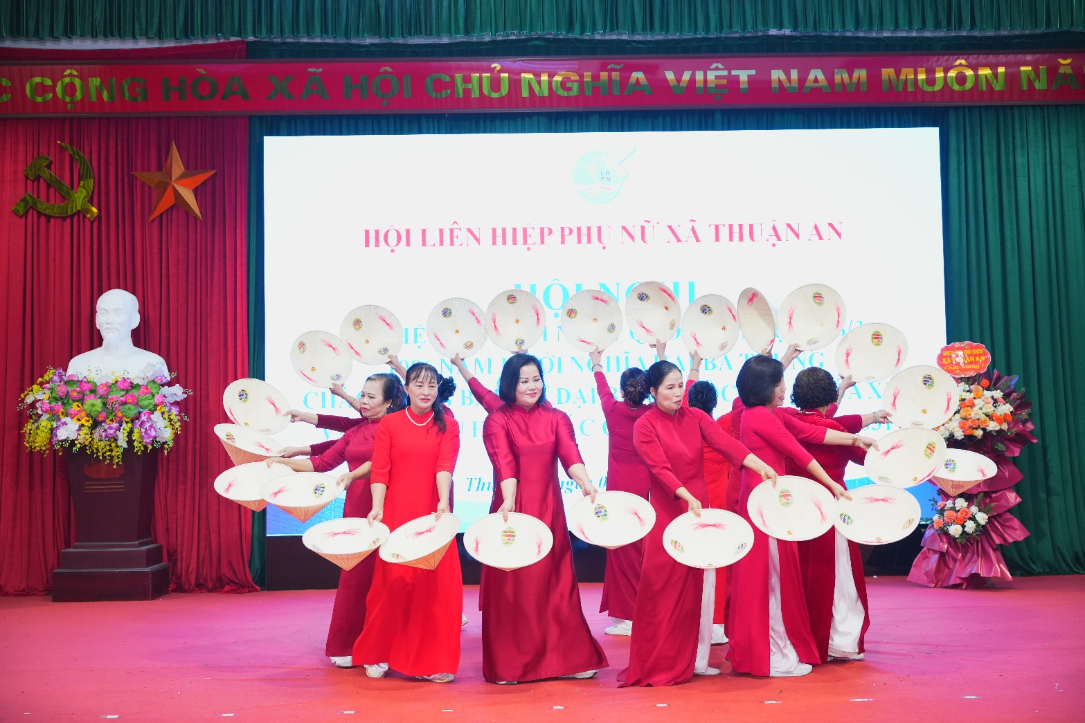 A group of women in red dresses on a stage  AI-generated content may be incorrect.