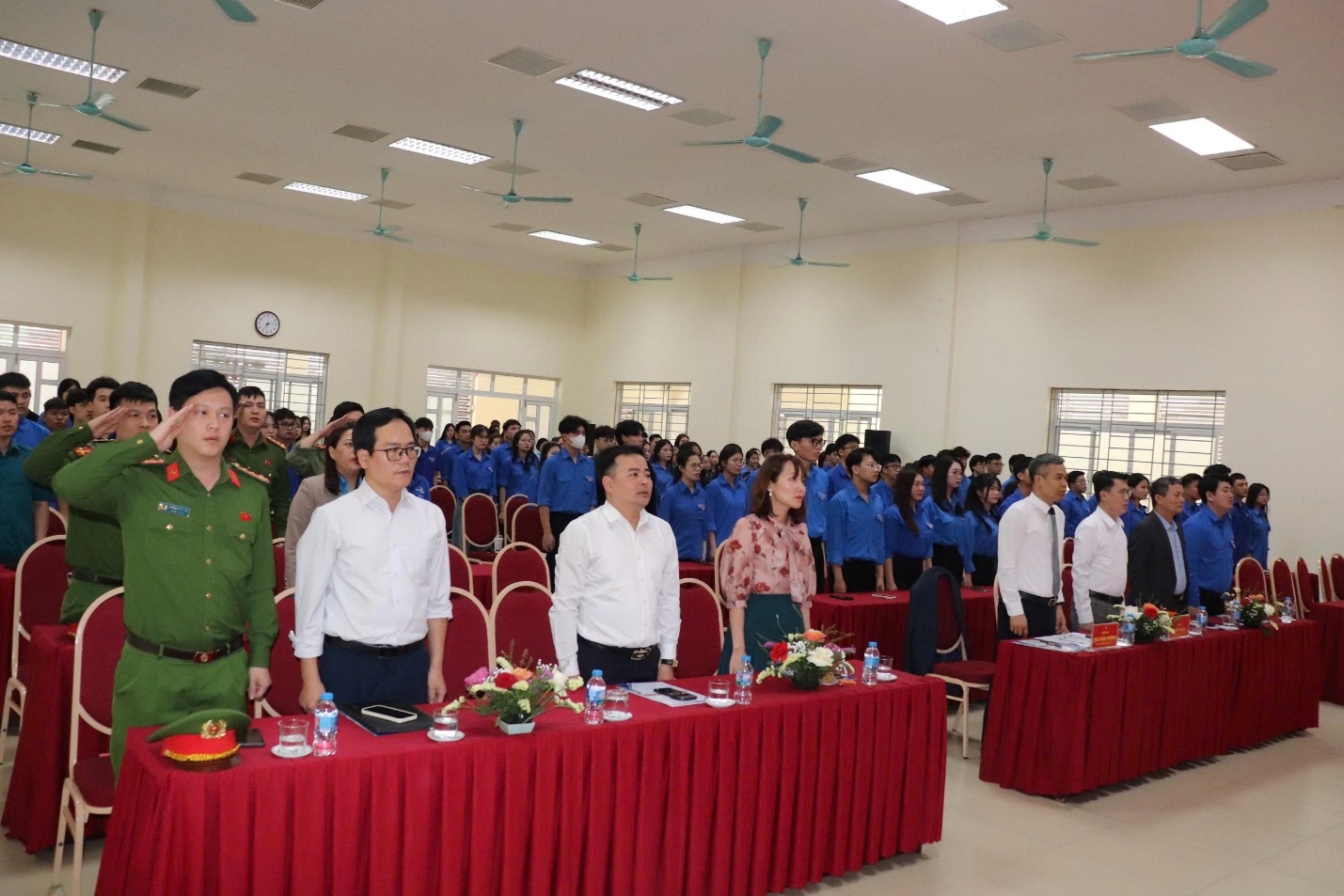 A group of people standing in a room  AI-generated content may be incorrect.