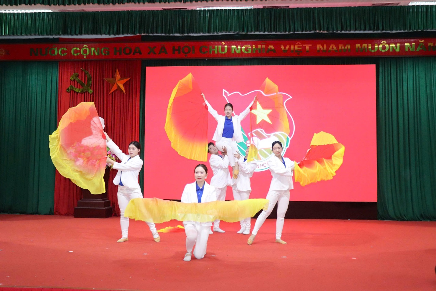 A group of people dancing on a stage  AI-generated content may be incorrect.