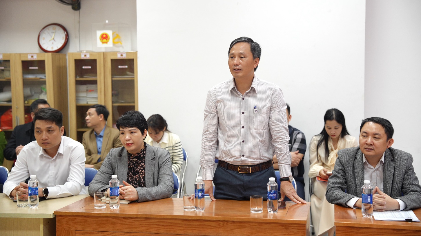 A person standing at a table with people in the background  AI-generated content may be incorrect.