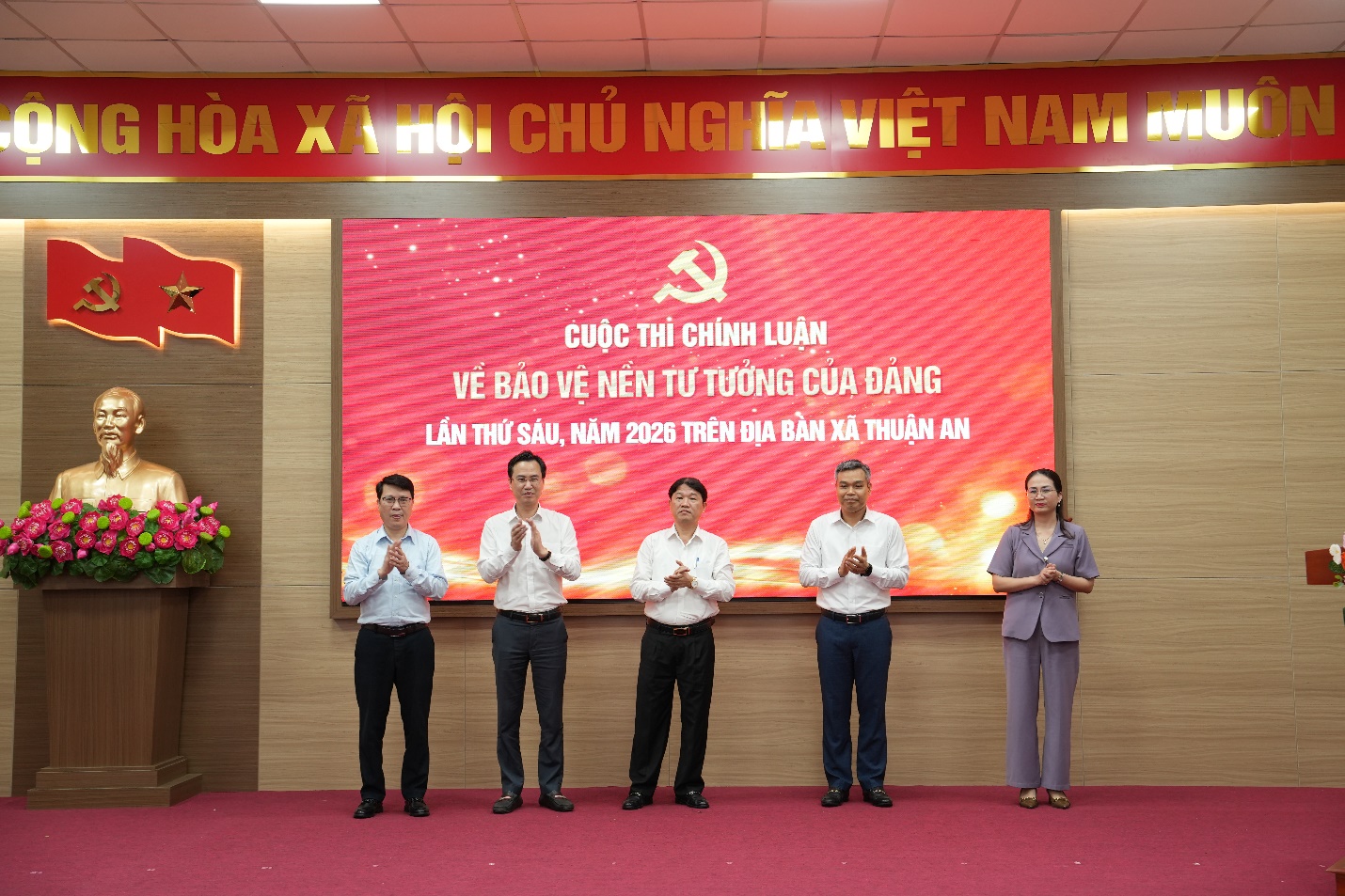 A group of people standing in front of a sign  AI-generated content may be incorrect.