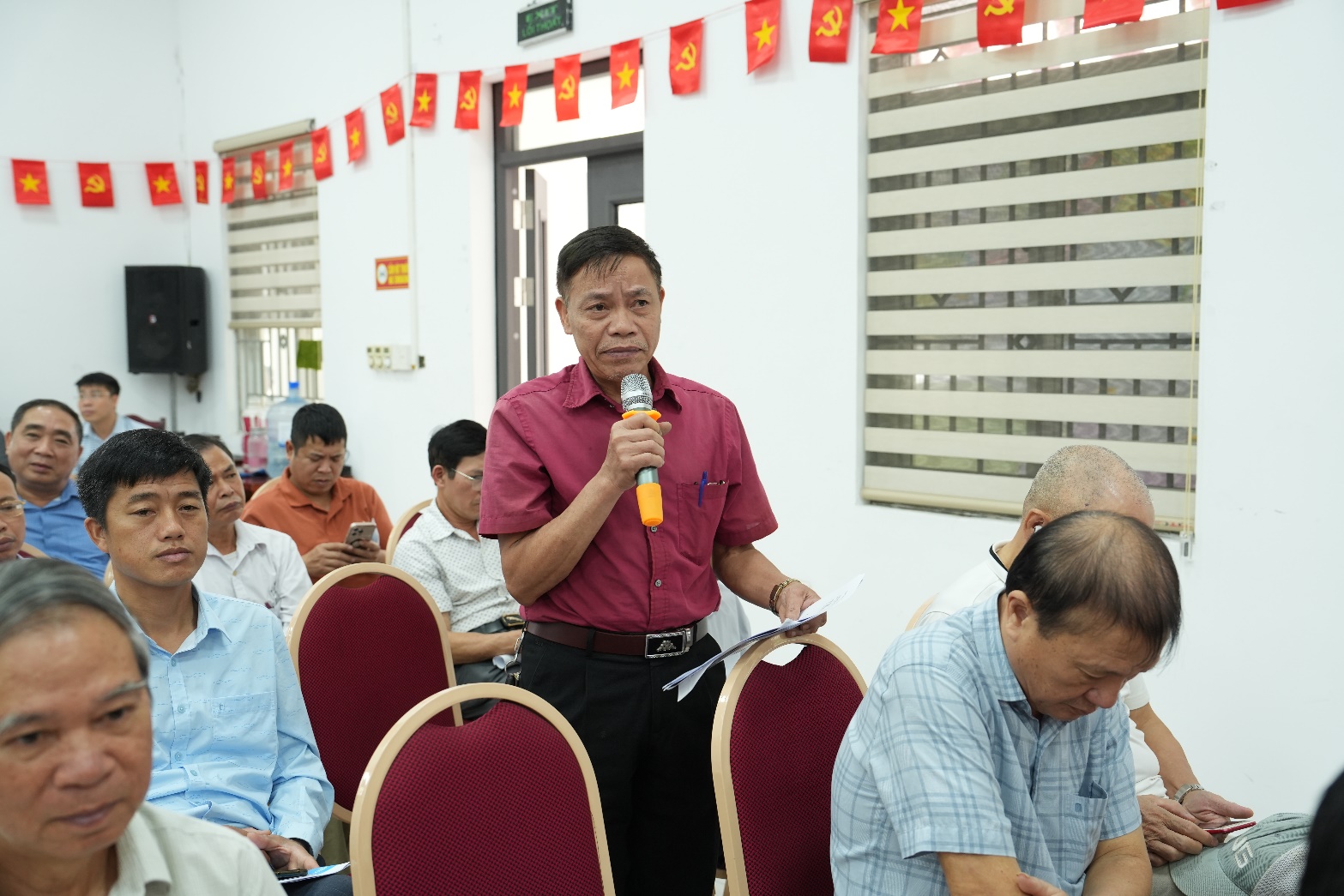 A person speaking into a microphone  AI-generated content may be incorrect.